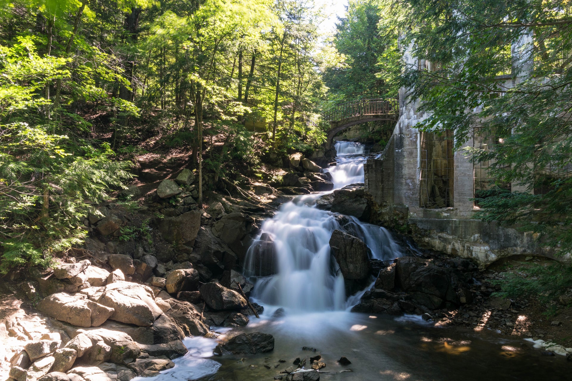 Scenic waterfall cascading near historic stone ruins